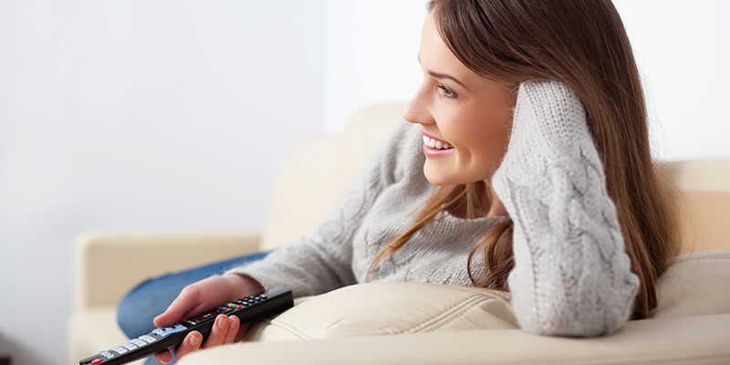 girl-smiling-watching-tv